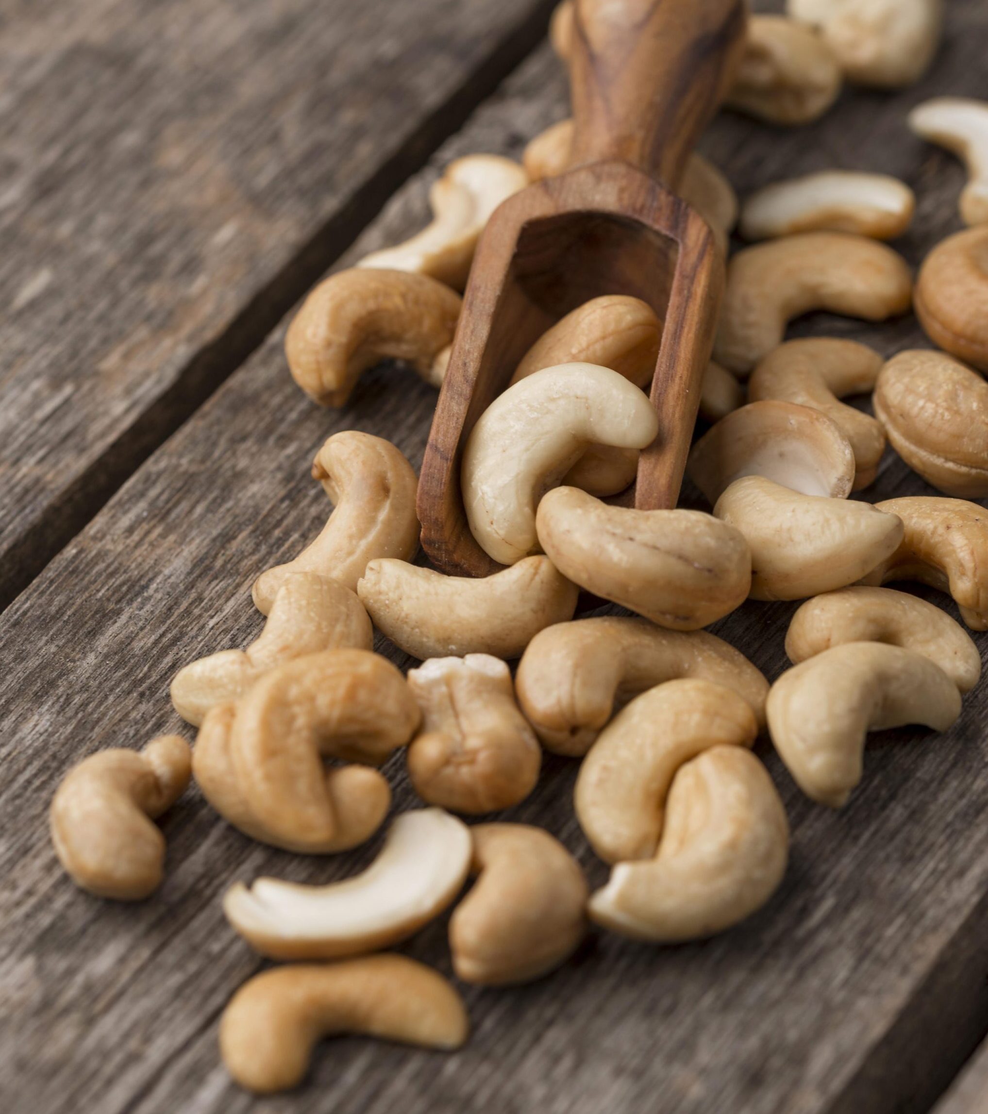 healthy-raw-cashew-nuts-small-wooden-spoon